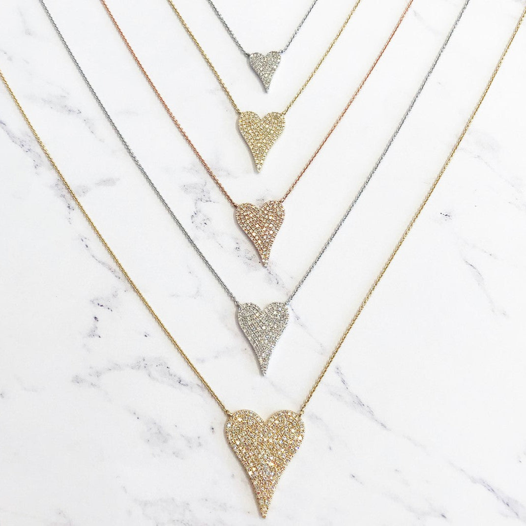 Pave diamond necklaces in rose, white, and yellow gold; and small, medium, and large sizes against a marbled background