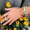 Diamond link statement bracelet worn with stacked yellow gold pave bangles and yellow gold ring