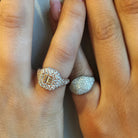 Diamond pinky ring beside rose gold pave diamond ring