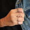 Rose gold evil eye chain bracelet worn with dainty pave rose gold bracelets and rings