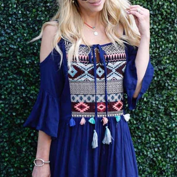 Girl wearing evil eye choker with blue knit/tassel dress