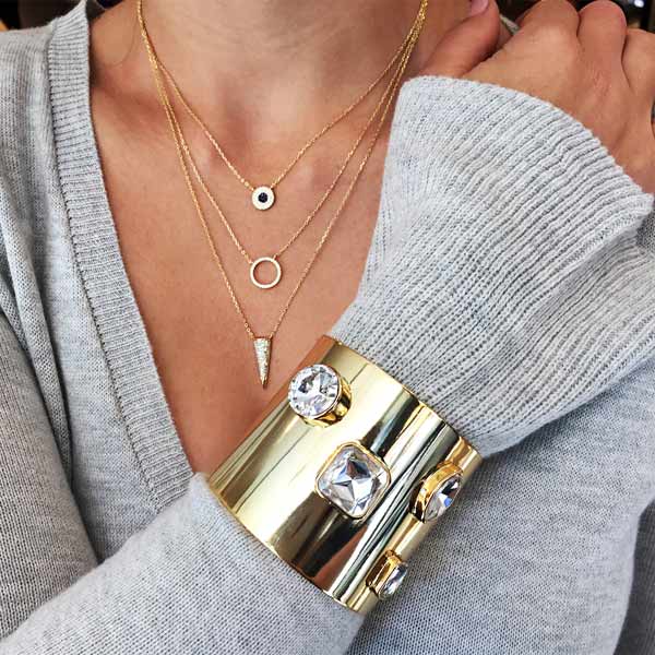 girl wearing Faux Pave Diamond Triple Layer Pendant Necklace   • Yellow Gold Plated • 16-18" Long • Pave Evil Eye, Pave Open Circle, Pave Triangle