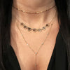 Woman wearing twinkle choker necklace layered with yellow gold chains
