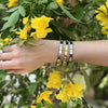Woman wearing yellow and white gold eternity bracelets
