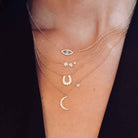 Diamond moon & star necklace layered with evil eye, starburst, and horseshoe necklaces